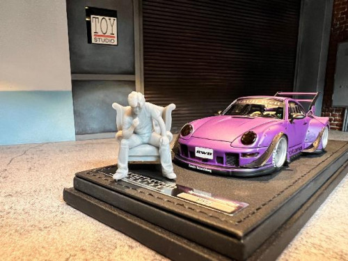 IG2322 1:43 RWB 993 Matt Purple With Mr.Nakai sitting on sofa