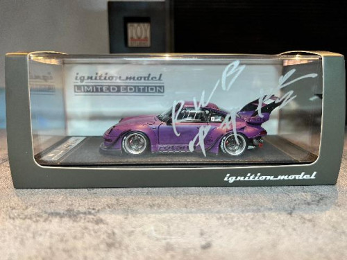 IG2322 1:43 RWB 993 Matt Purple With Mr.Nakai sitting on sofa