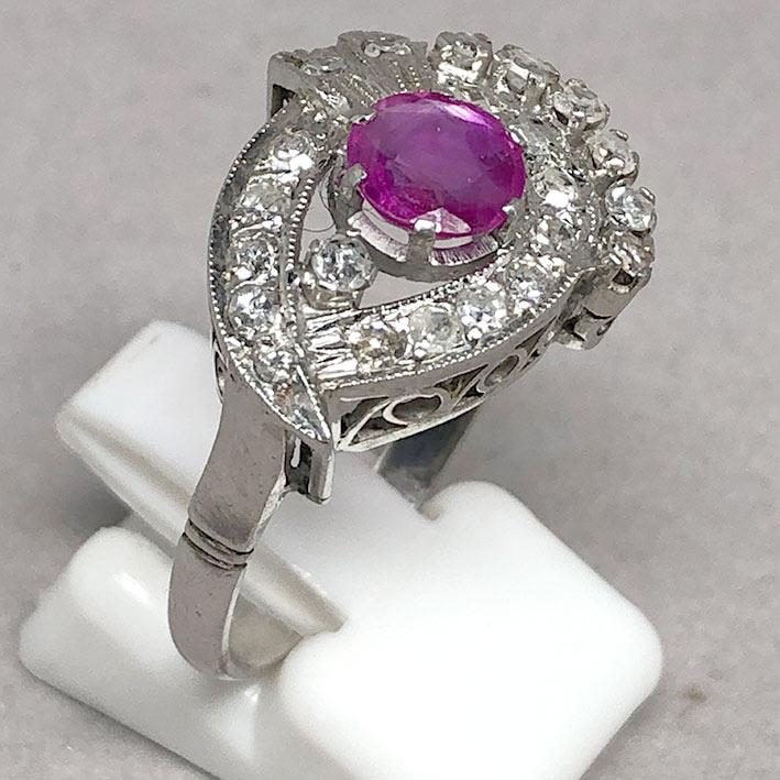 A gold ring set with 22 rose-cut diamonds totaling 0.66 carats, and adorned with genuine faceted rub 1