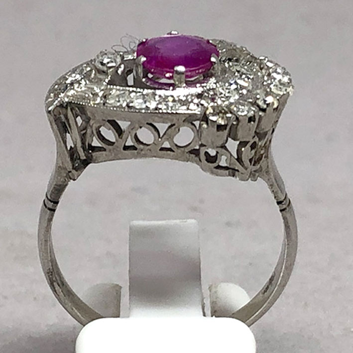 A gold ring set with 22 rose-cut diamonds totaling 0.66 carats, and adorned with genuine faceted rub 2